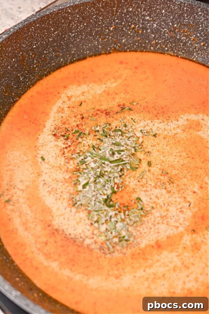 Step 7: Mixing fresh rosemary into the creamy sauce.