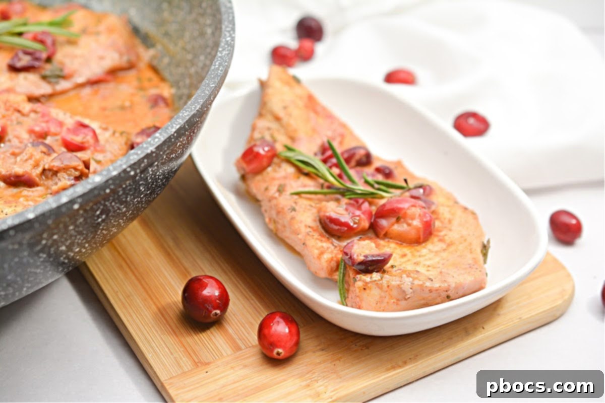 Ingredients for Creamy Keto Cranberry Rosemary Chicken Skillet laid out on a cutting board.