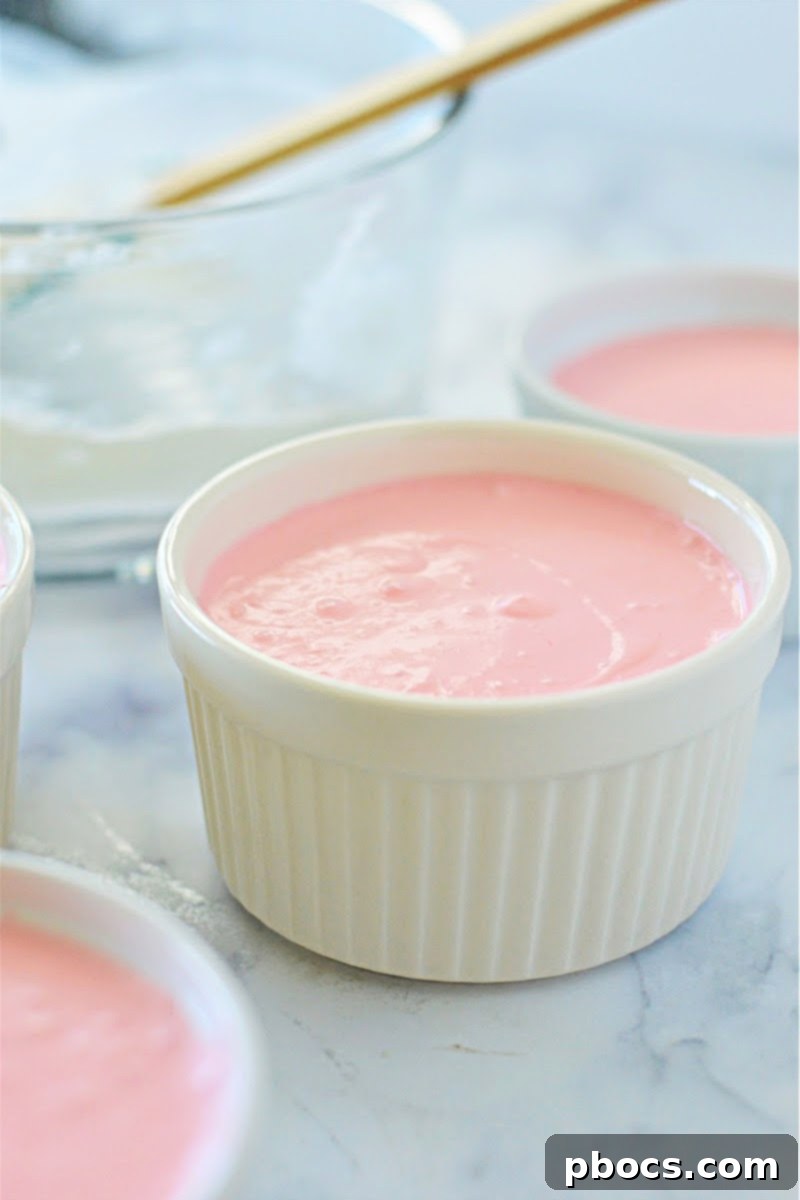 Airy Strawberry Keto Delight 12 Step 5: Folding whipped cream into the strawberry jello mixture