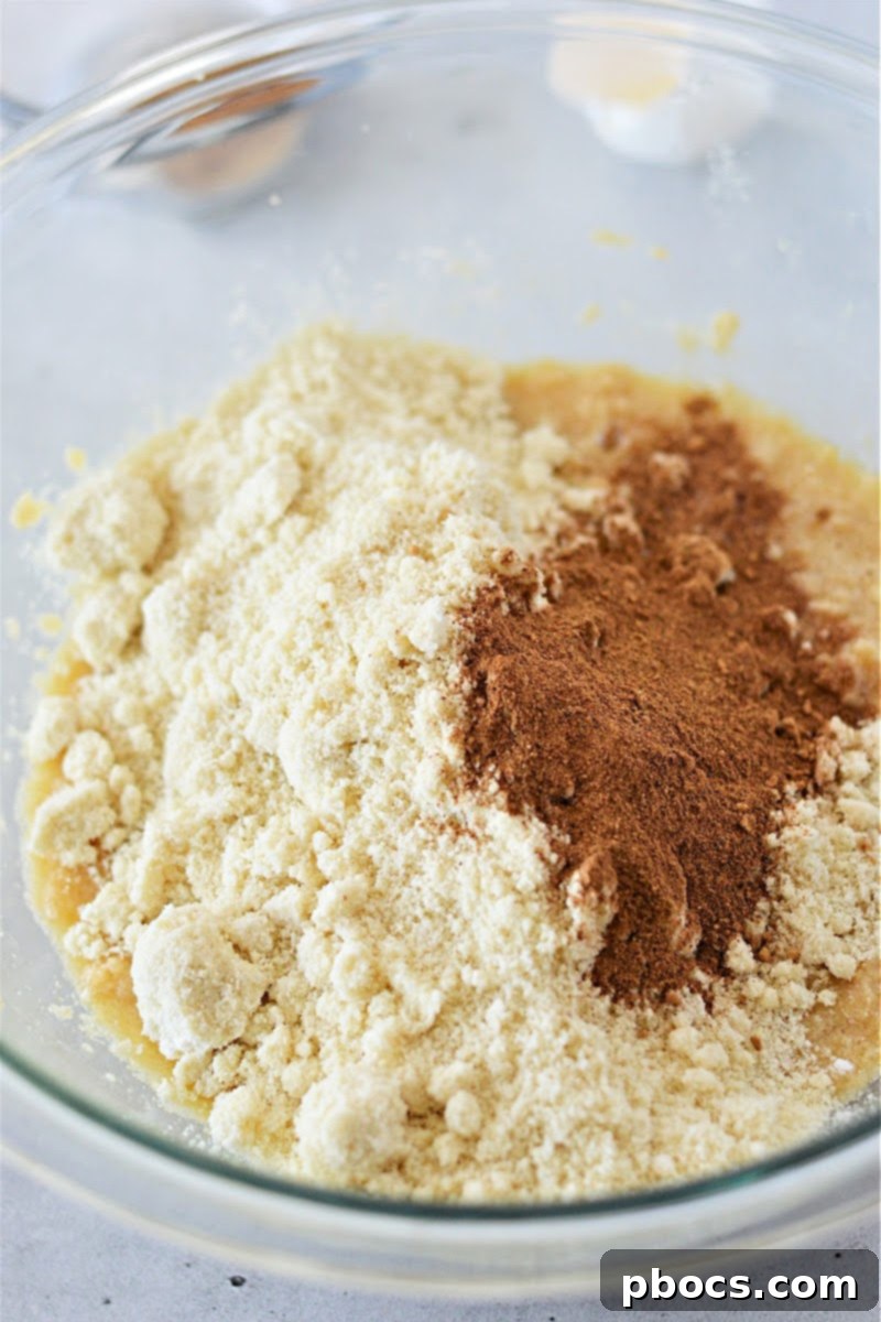 Adding egg to gingerbread cookie dough mixture