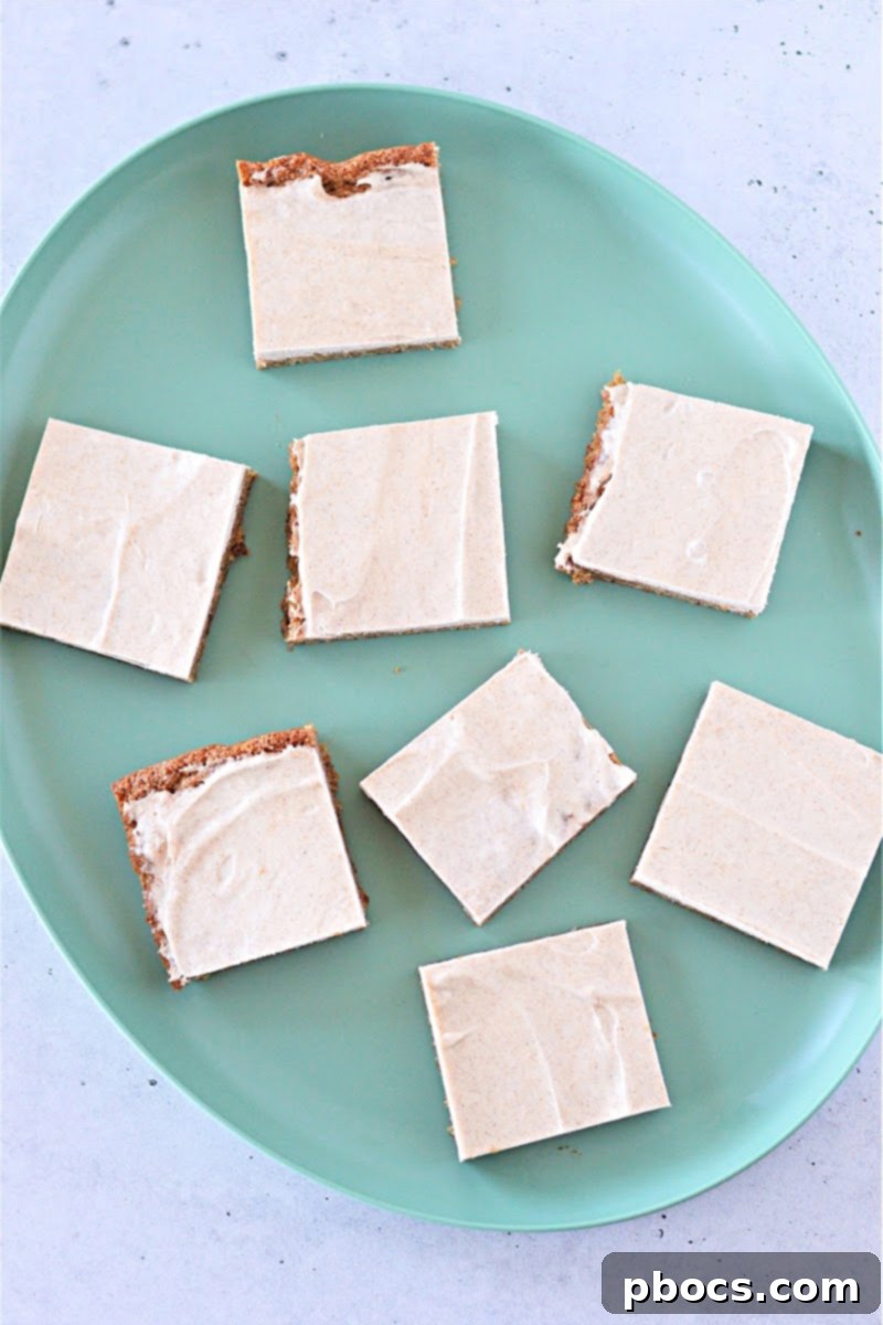 Cream cheese frosting being spread on Keto Gingerbread Cookie Bars