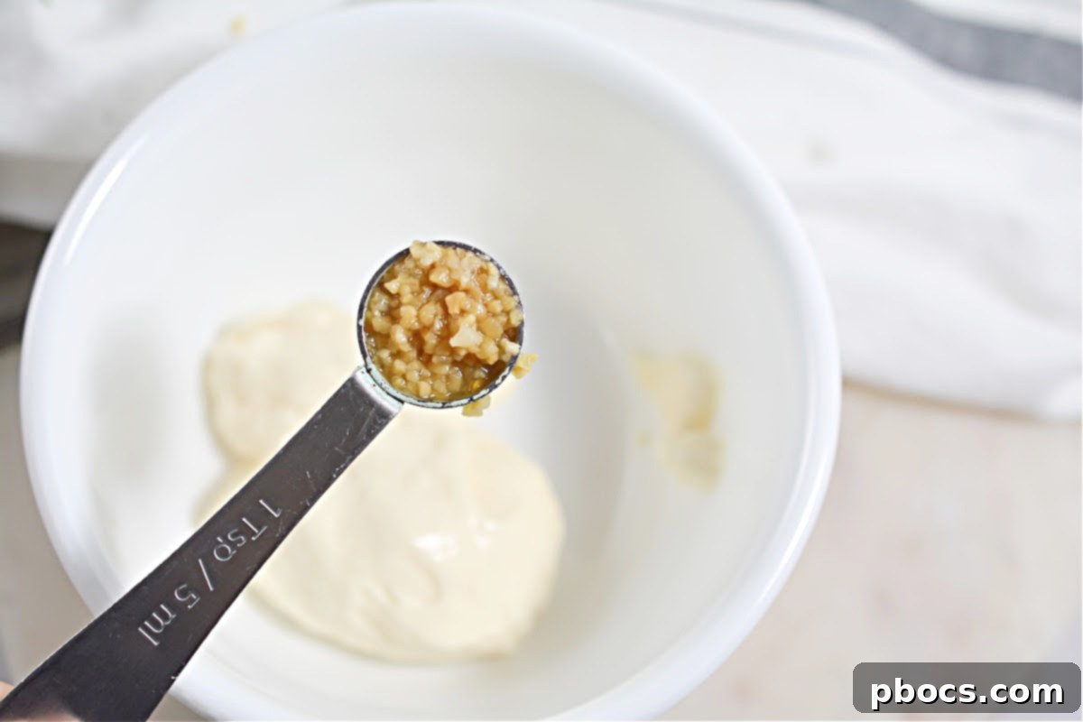 Draining cooked Keto Cheesy Chicken Fritters on paper towels