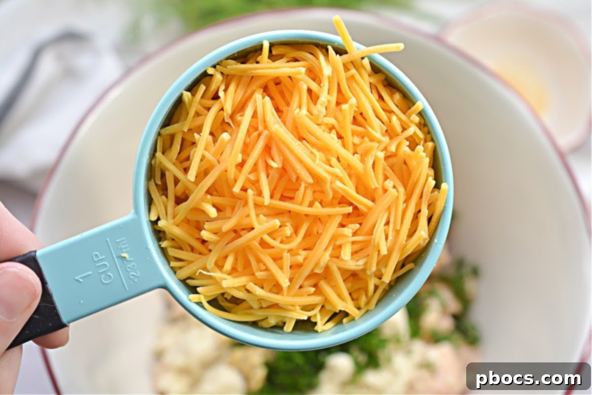 Mixing ingredients for Keto Cheesy Chicken Fritters