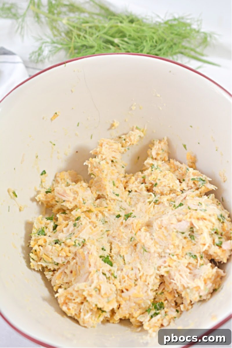 Keto Cheesy Chicken Fritters mixture being kneaded