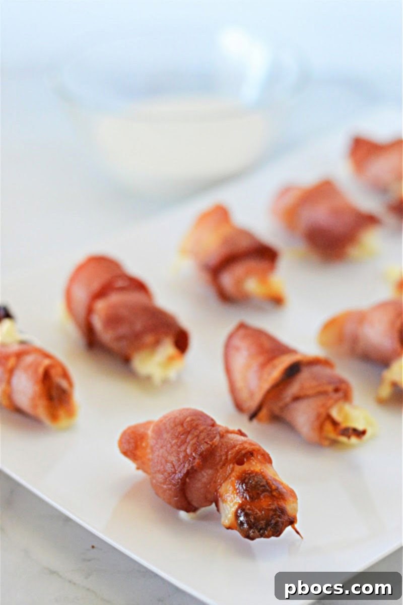 Keto Bacon Wrapped Mozzarella Sticks served with a side of keto ranch