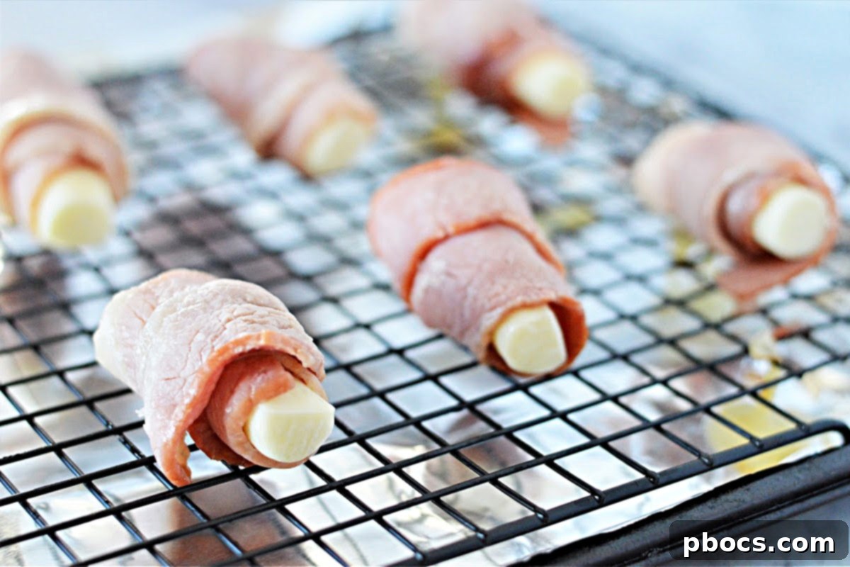 Step 3: Wrapping frozen cheese sticks with par-cooked bacon