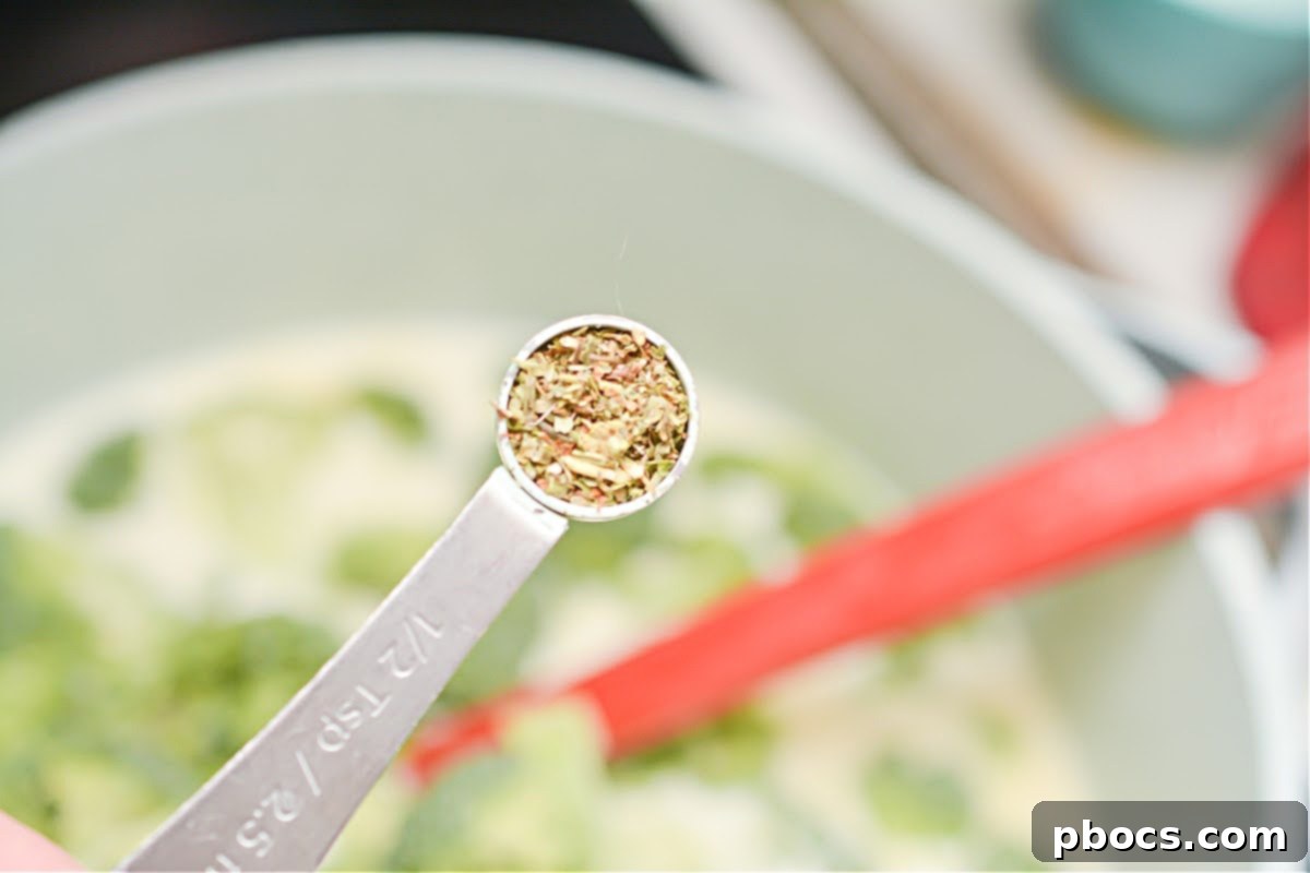 Creamy Keto Chicken Alfredo Soup 13 Adding broccoli and Italian seasoning to the soup