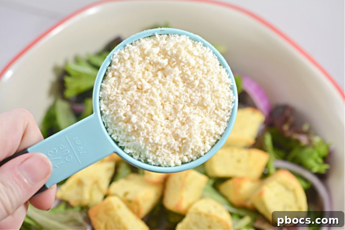 The fully assembled Keto Copycat Olive Garden Salad in a large bowl, with dressing, croutons, and parmesan cheese tossed.
