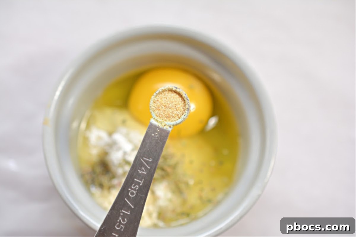 The mixture for keto croutons in a ramekin, ready to be microwaved, showing its dough-like consistency.