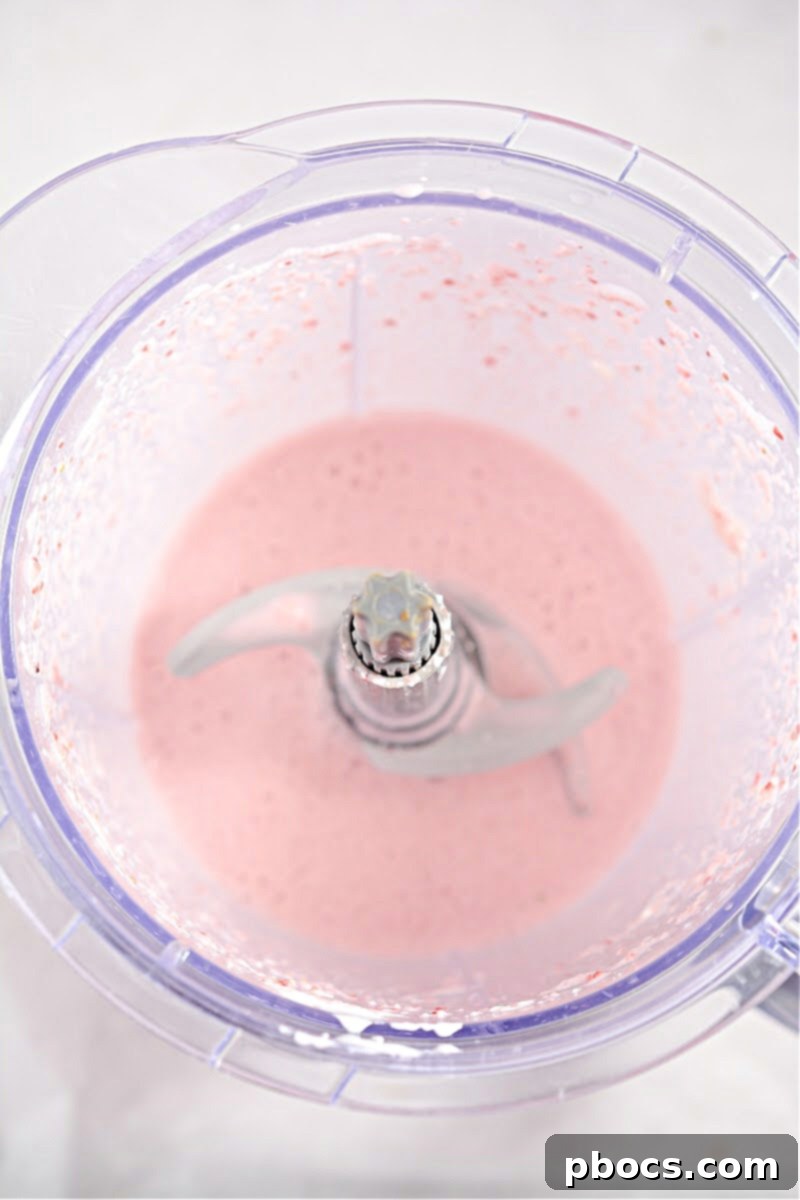 Pouring Keto Strawberry Cheesecake Smoothie