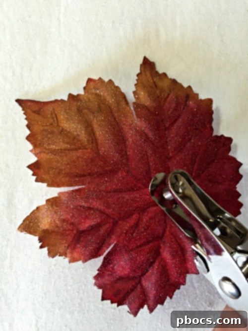 Punching holes in glittered craft leaves