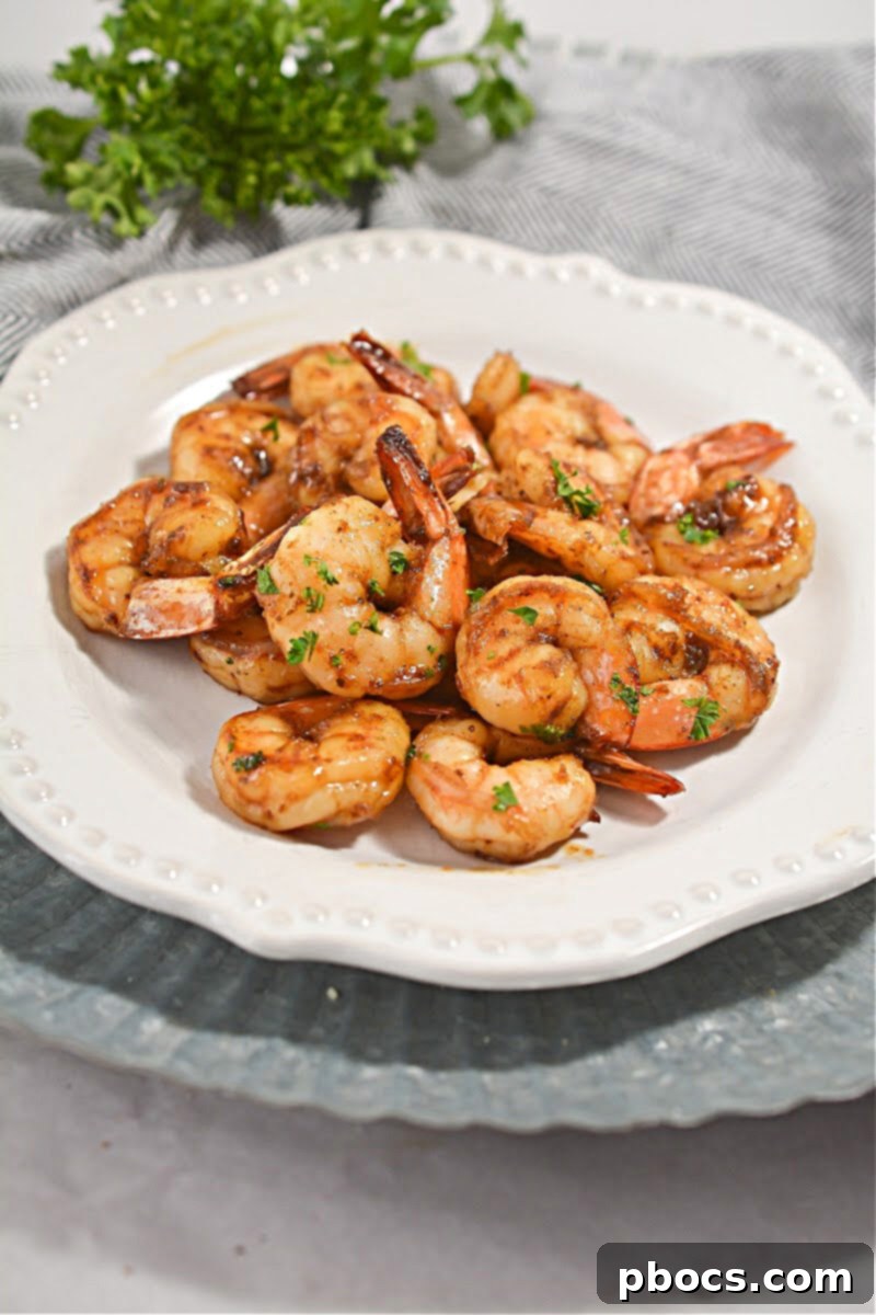 Delicious Keto Honey Old Bay Shrimp served in a bowl, garnished with fresh parsley.