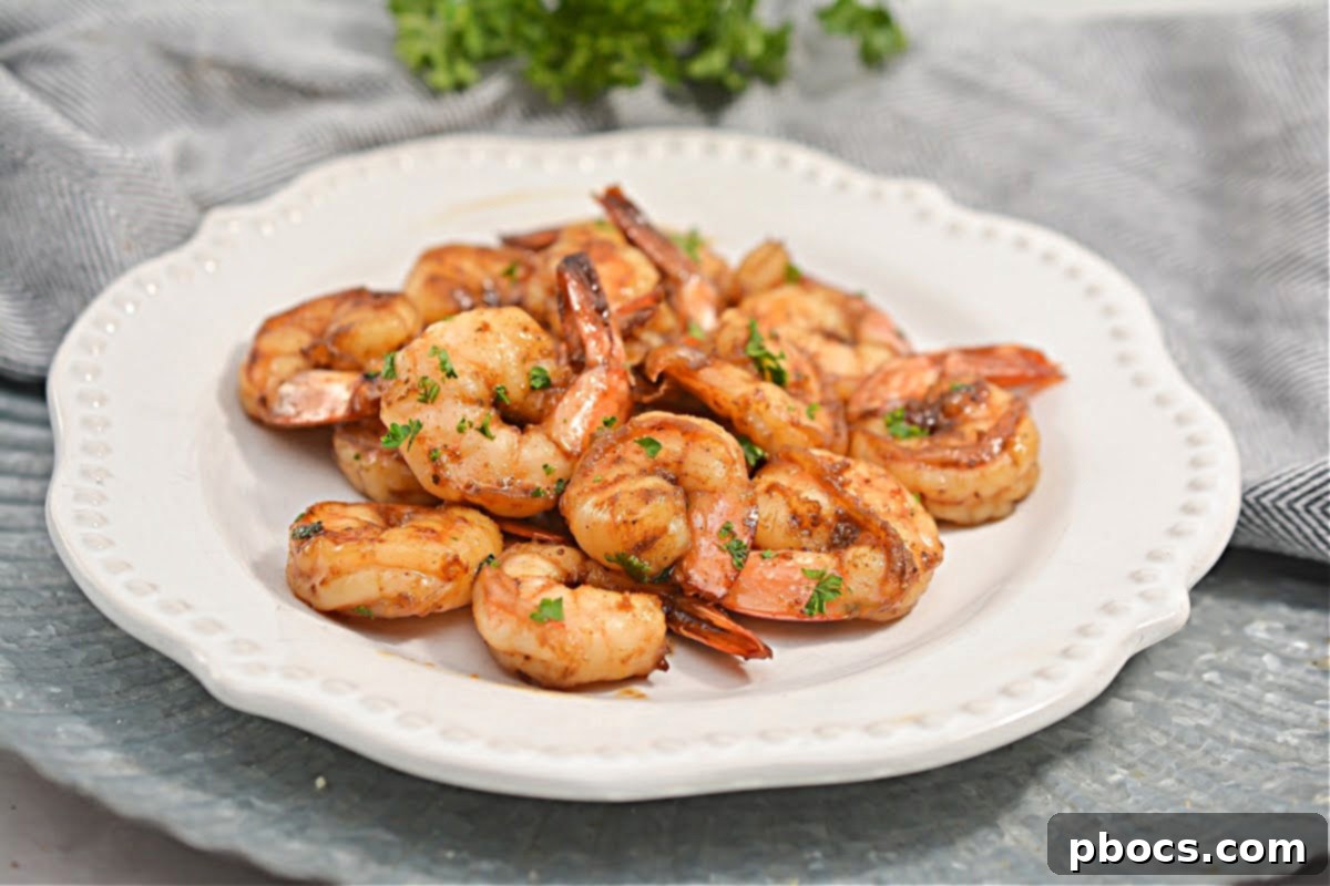 Close-up of fresh shrimp generously coated in vibrant Old Bay Seasoning, ready for cooking.