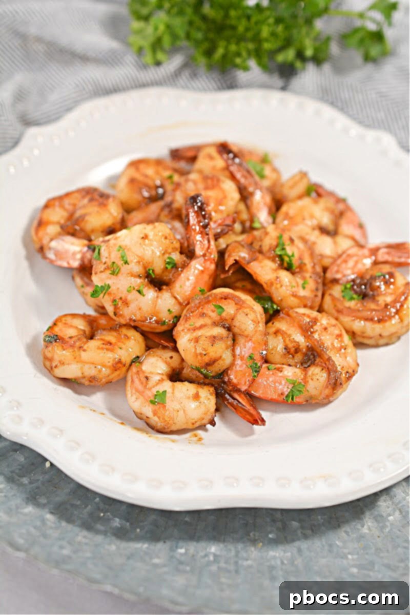 Plated Keto Honey Old Bay Shrimp with a side of fresh green salad and lemon wedges, showcasing a complete meal.