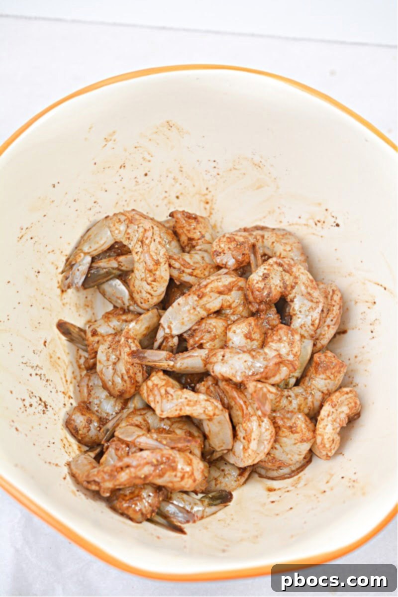 Close-up of vibrant, seasoned shrimp, perfectly coated and ready for the skillet.
