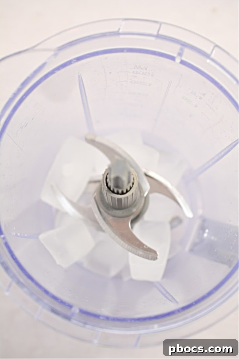 Mixing ingredients for Keto White Claw Slushie in blender