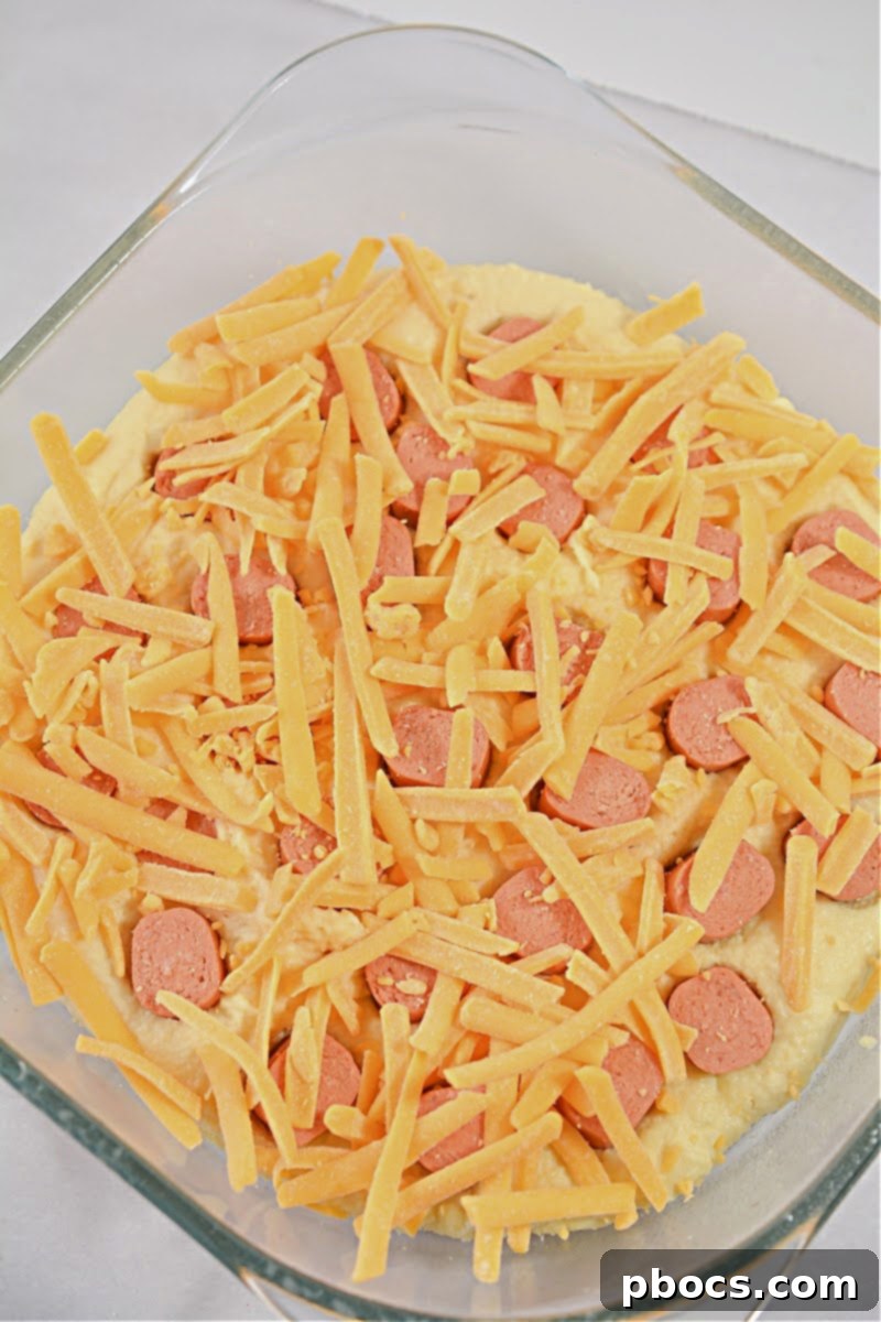 Adding hot dog pieces to Keto Hot Dog Casserole