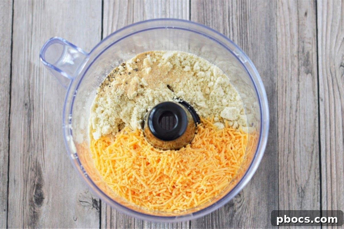 Mixing ingredients for Keto Cheese Crackers in a food processor