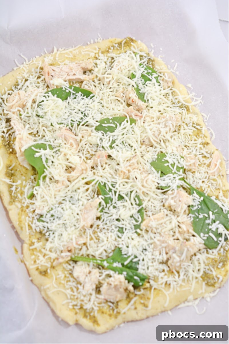 Baked Keto Chicken Pesto Flatbread with a golden brown crust, fresh from the oven.