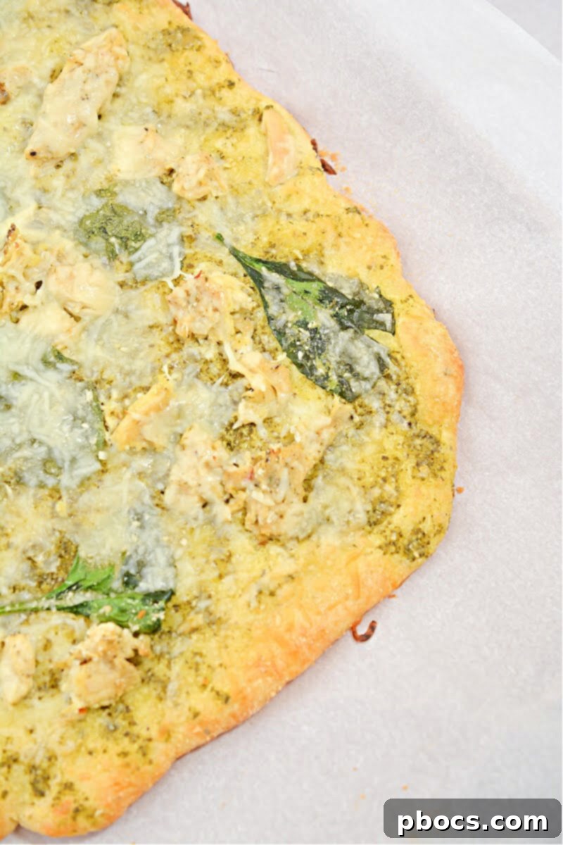 Close-up of freshly baked Keto Chicken Pesto Flatbread, highlighting its golden crust and vibrant toppings.