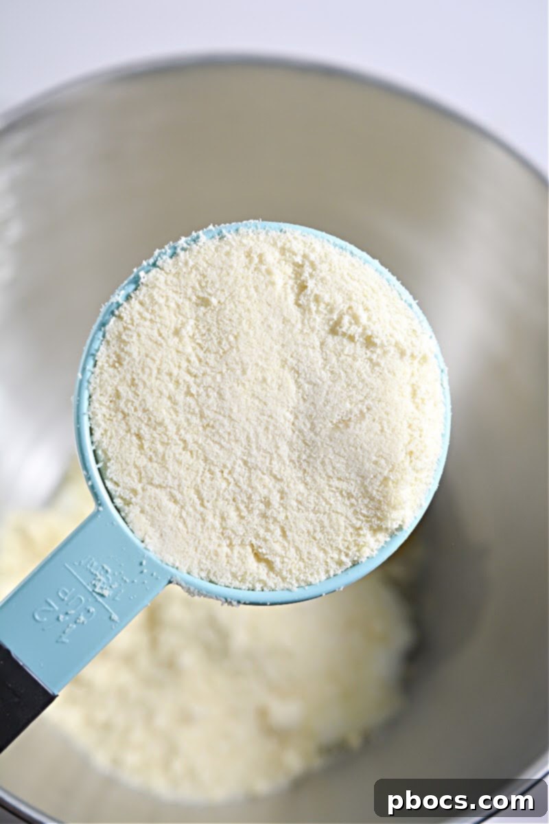 Adding almond flour, xanthan gum, baking soda, egg, and Italian seasoning to the melted cheese.