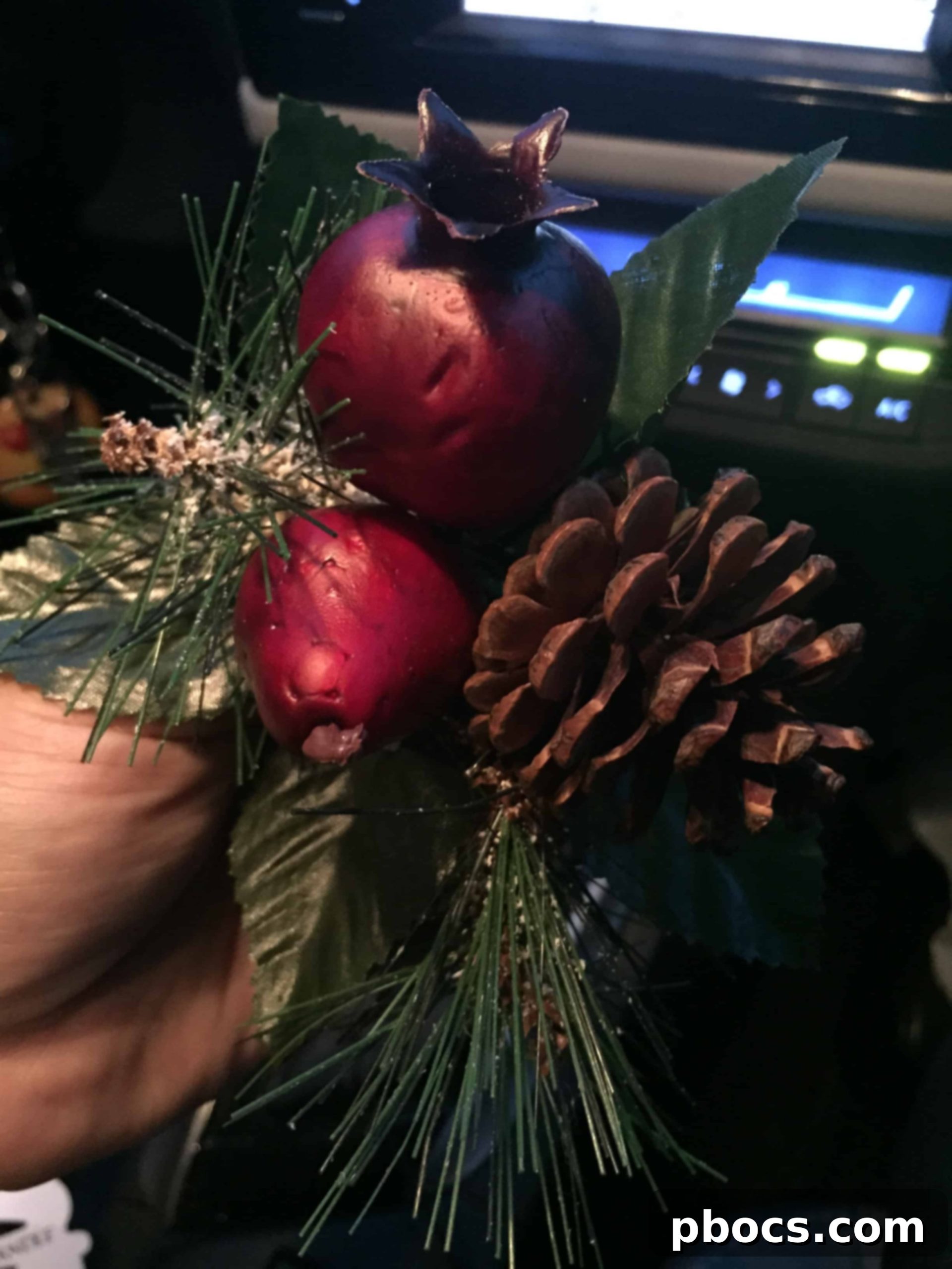 Car interior adorned with subtle holiday decorations and a Yankee Candle air freshener, creating a festive ambiance