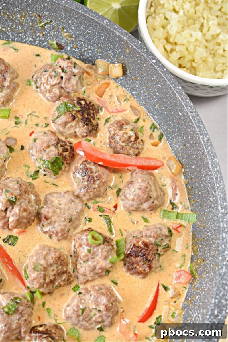 Spicy Keto Thai Meatballs 6 Keto Thai Meatballs cooking in a skillet