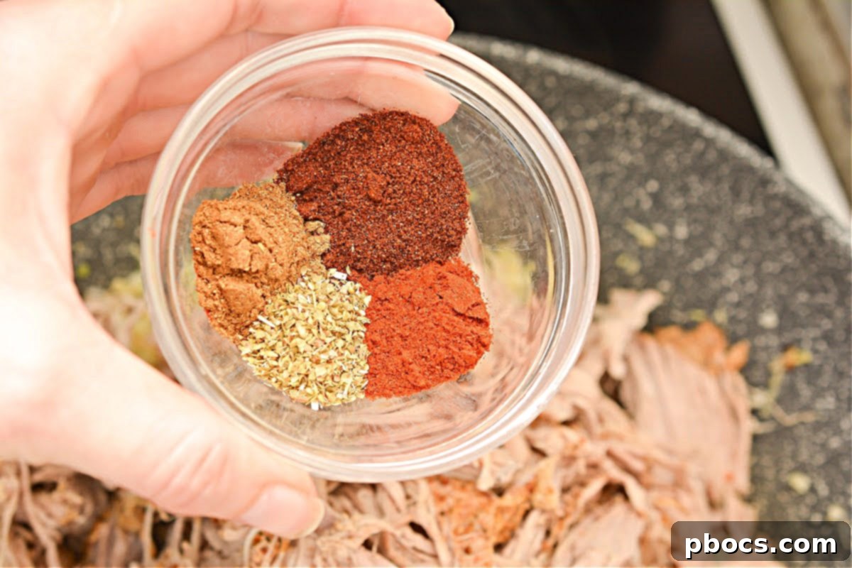 Keto Fiesta Pulled Pork Taco Casserole 12 Spreading the pulled pork mixture into a baking dish