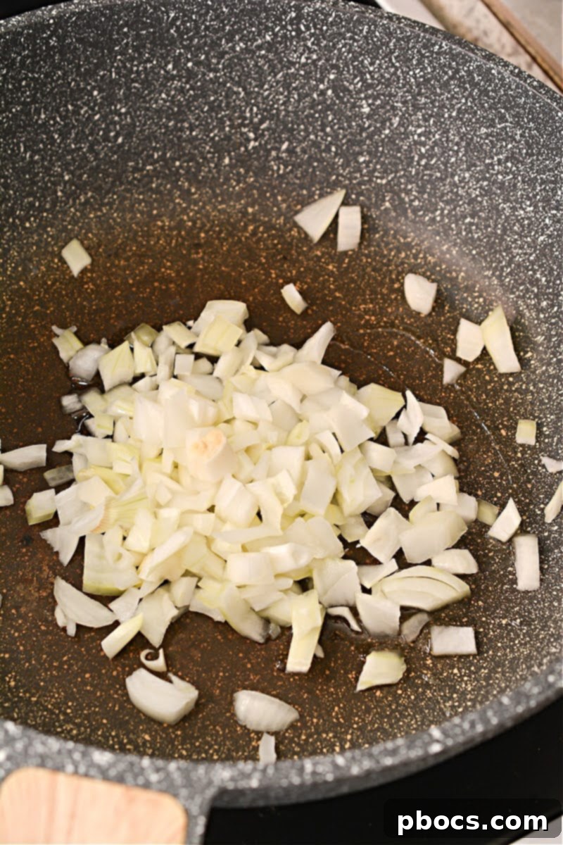 Keto Fiesta Pulled Pork Taco Casserole 8 Sautéing onions in a skillet for Keto Mexican Pulled Pork Casserole