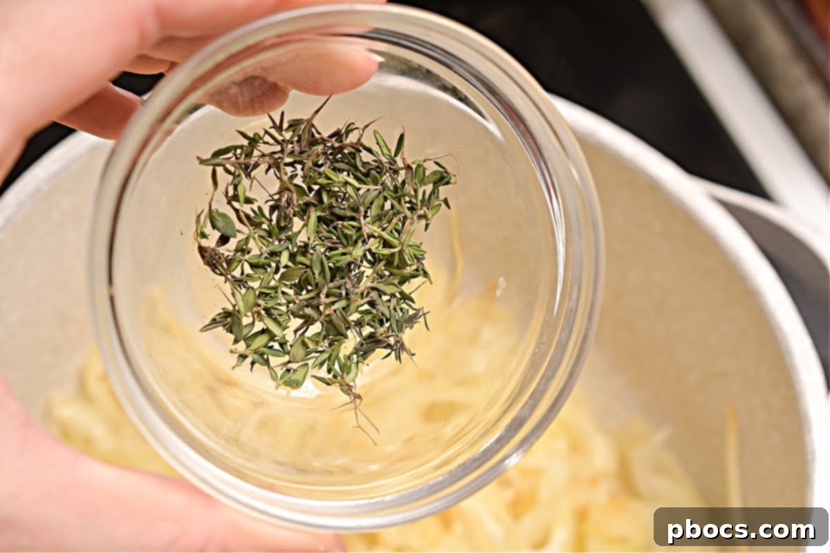 Adding garlic and thyme to caramelized onions