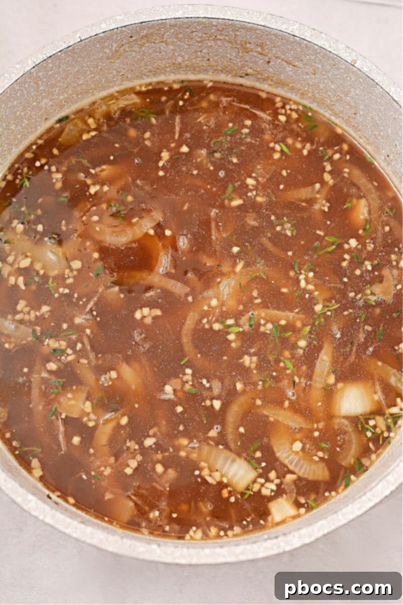 Adding beef broth to the onion mixture