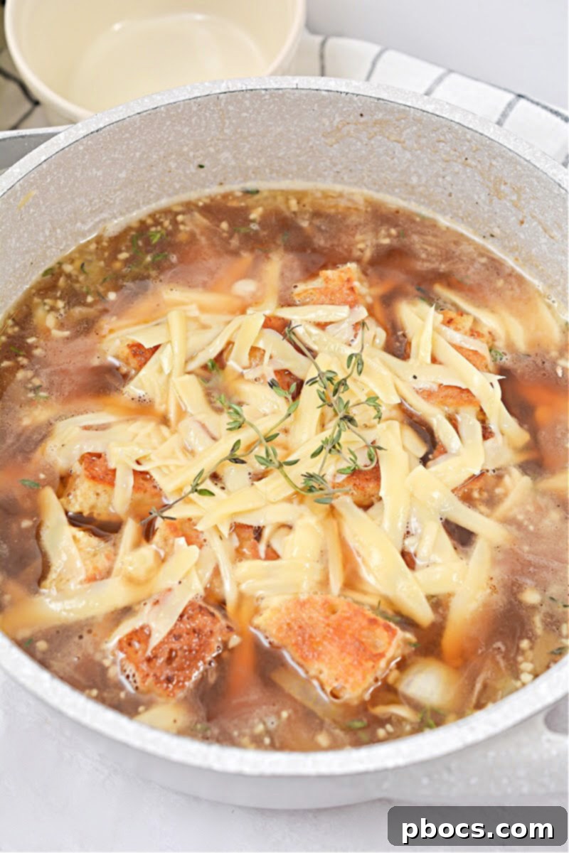 Keto French Onion Soup served in a traditional ramekin with a spoon, highlighting the melted cheese