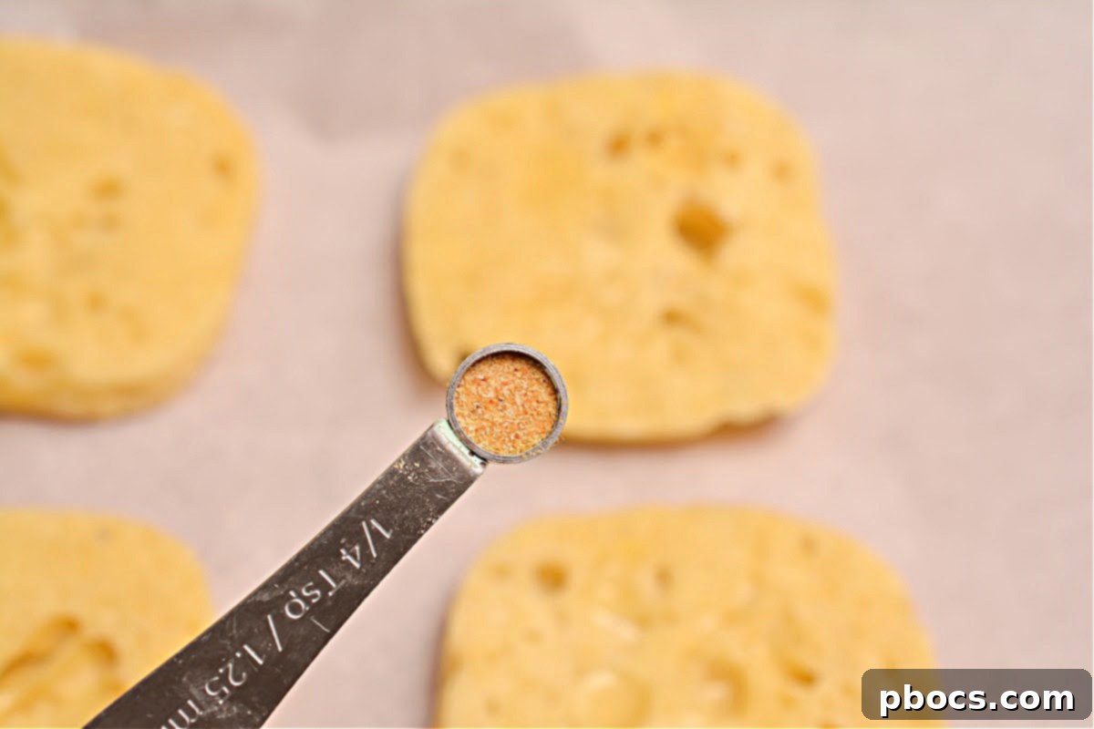 Brushing melted butter on keto bread for croutons