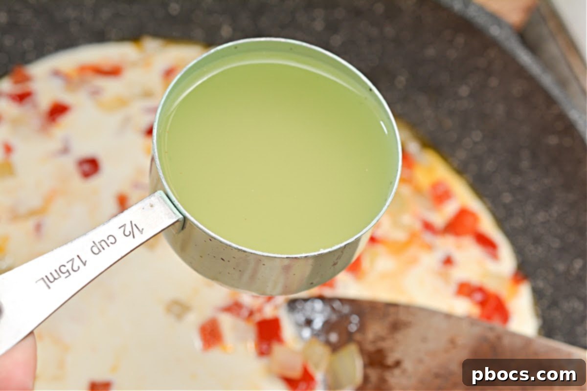 Further close-up of bell peppers and onions sautéing in a skillet, nearly tender and ready for the next step.