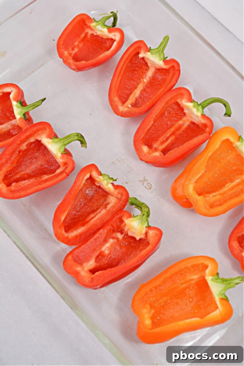 Hearty Keto Sausage Stuffed Bell Peppers 8 Slicing bell peppers in half for stuffing