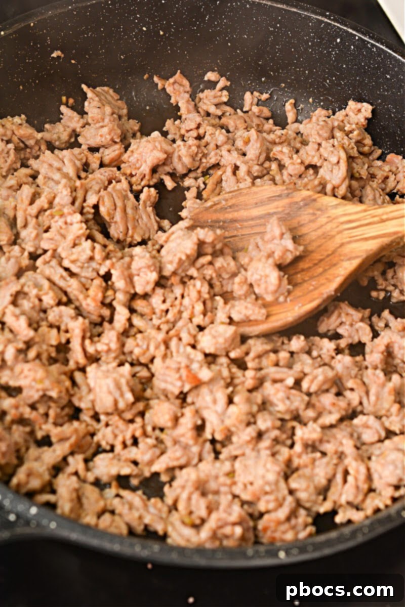 Hearty Keto Sausage Stuffed Bell Peppers 10 Sautéing ground Italian sausage in a skillet