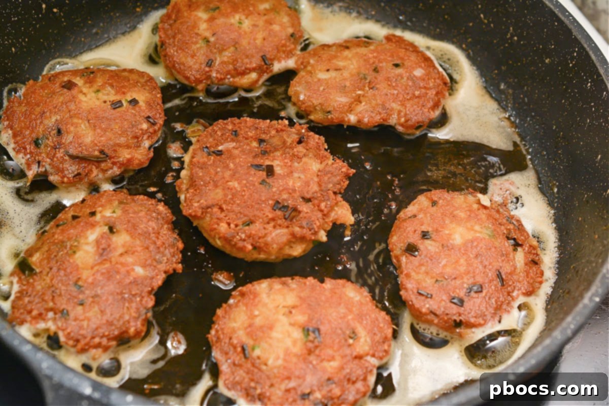 Sautéing Keto Crab Cakes until golden brown and crispy.