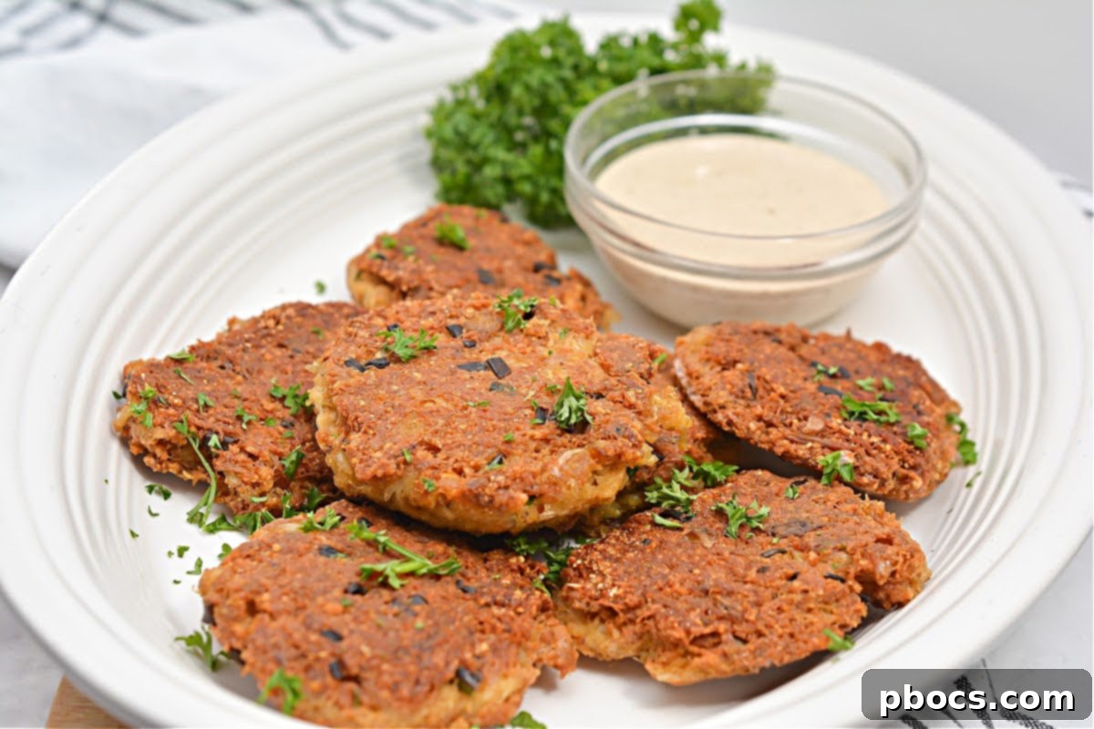 Serving freshly cooked Keto Crab Cakes with the homemade dipping sauce.