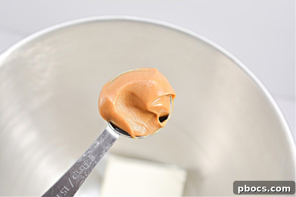 Pressing Keto Peanut Butter Cup Crust into Liners