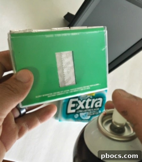 Custom Chalkboard Gum Storage Frame 7 Applying spray adhesive to the back of an Extra Gum 35-stick pack