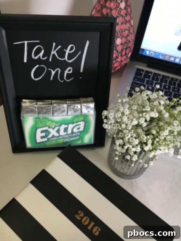 Custom Chalkboard Gum Storage Frame 10 Detail shot of the DIY Chalkboard Frame Gum Holder with a hand holding a stick of gum
