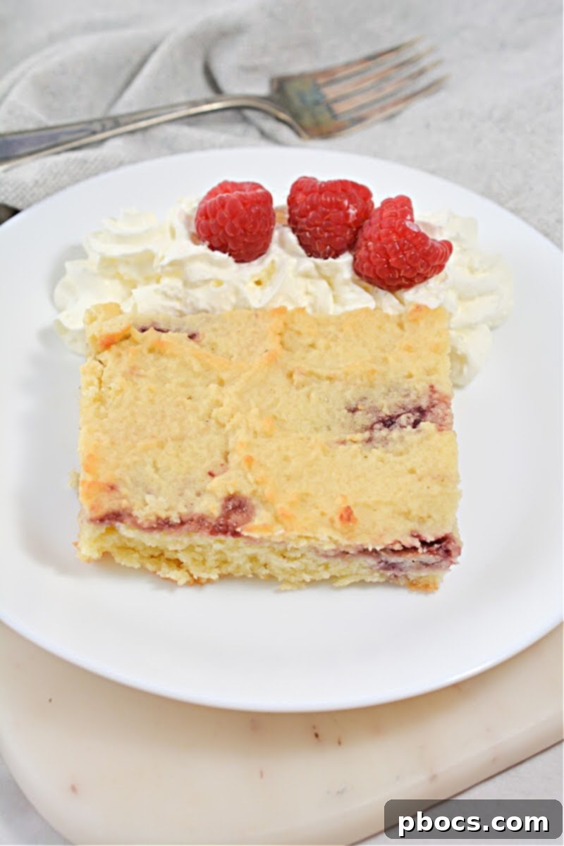 Dropping remaining batter over jam swirls for Keto Raspberry Swirl Cake Bars.