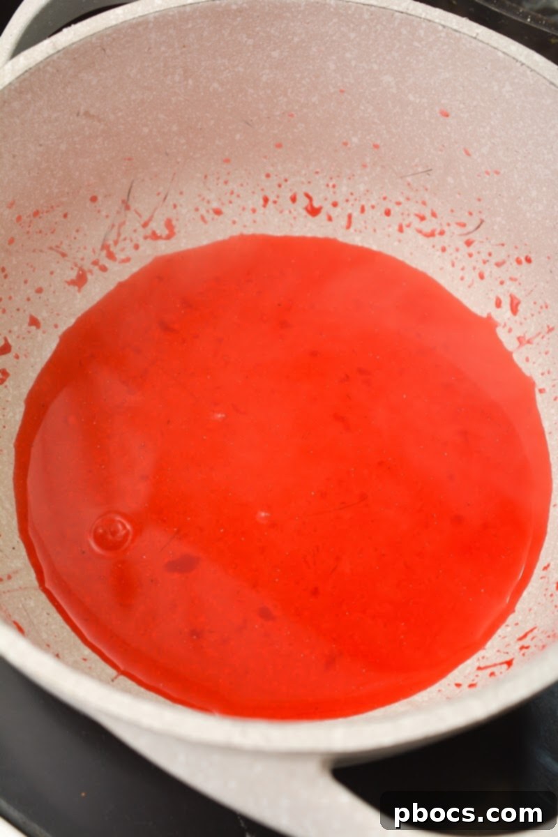 Delicious Keto Strawberry Mini Pies 12 Jello powder being whisked into boiling water and sweetener