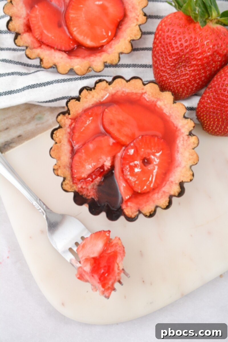 Delicious Keto Strawberry Mini Pies 4 Keto Strawberry Mini Pies displayed in their individual tins, ready to be served