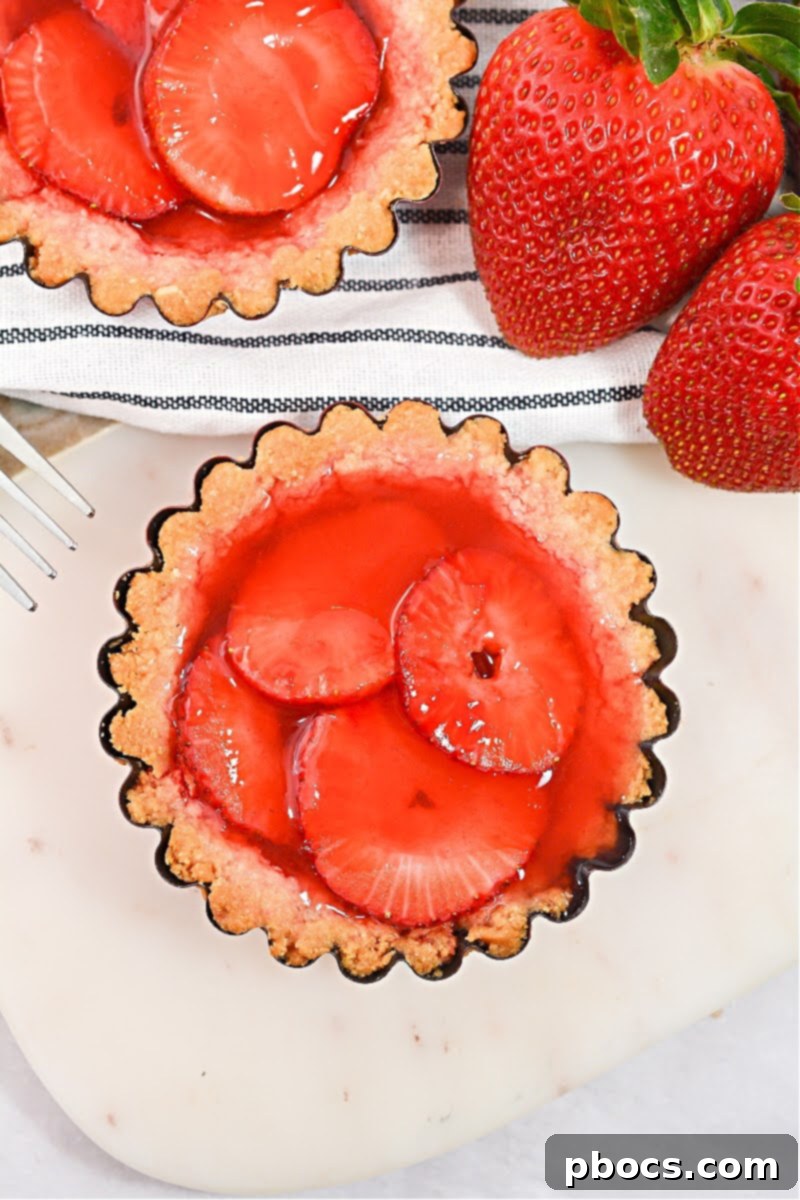 Delicious Keto Strawberry Mini Pies 5 Keto Strawberry Mini Pies garnished with fresh mint and berries