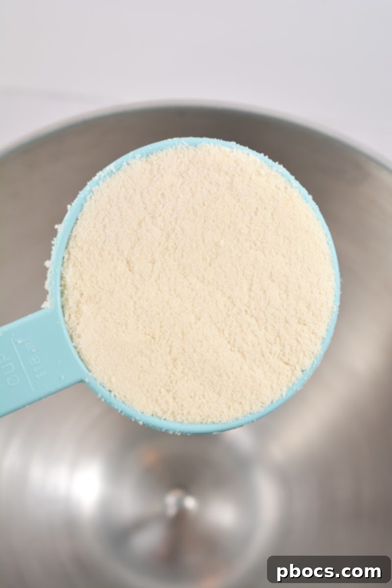 Delicious Keto Strawberry Mini Pies 8 Mixing almond flour, butter, Swerve, and vanilla extract for keto pie crust