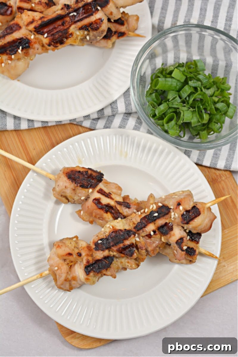 Sticky Keto Chicken Yakitori Skewers 2 Delicious Keto Yakitori Chicken Skewers on a plate, ready to be served