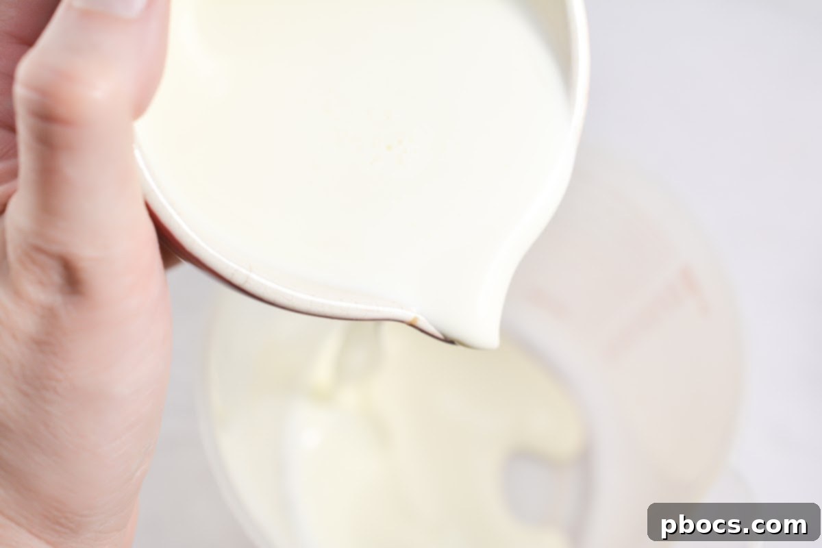Step 3: Mixing liquid ingredients for Keto Pink Drink in a container.