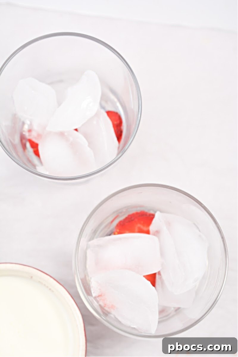 Step 2: Adding ice and more strawberries to the cups.