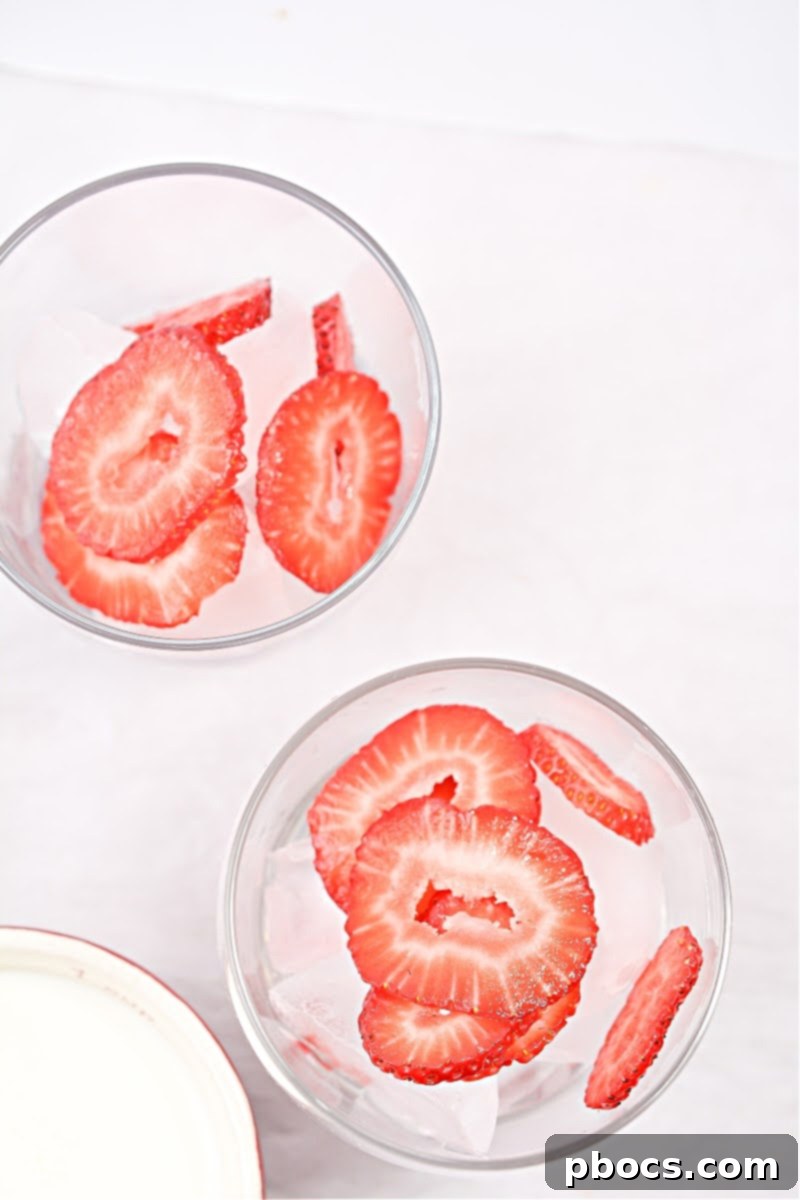 Cups filled with ice and strawberries.